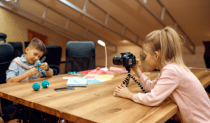an image of a child recording a video of another child