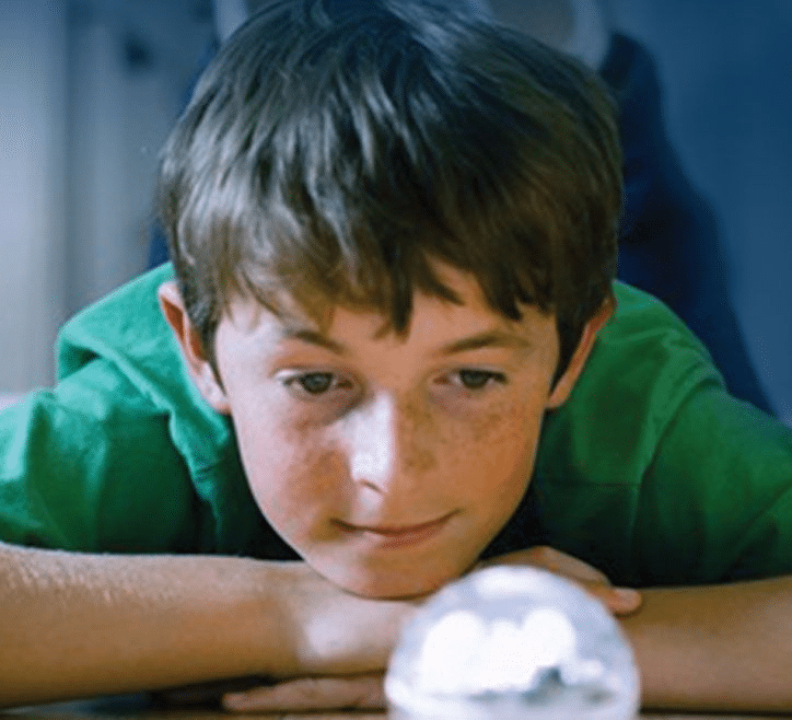 an image of child looking at a snow globe