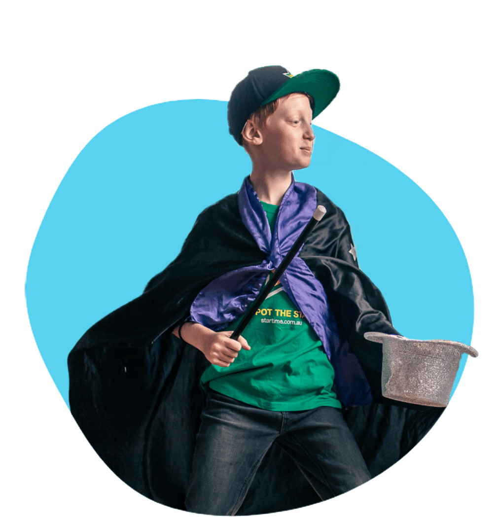 an image of a young boy wearing a cape practicing magic