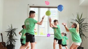 an image of children playing with balloons