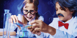 an image of children playing a lab wearing lab coats