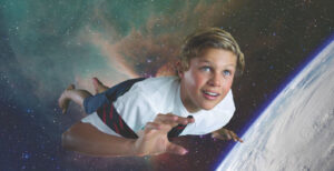an image of young boy in school uniform flying through space